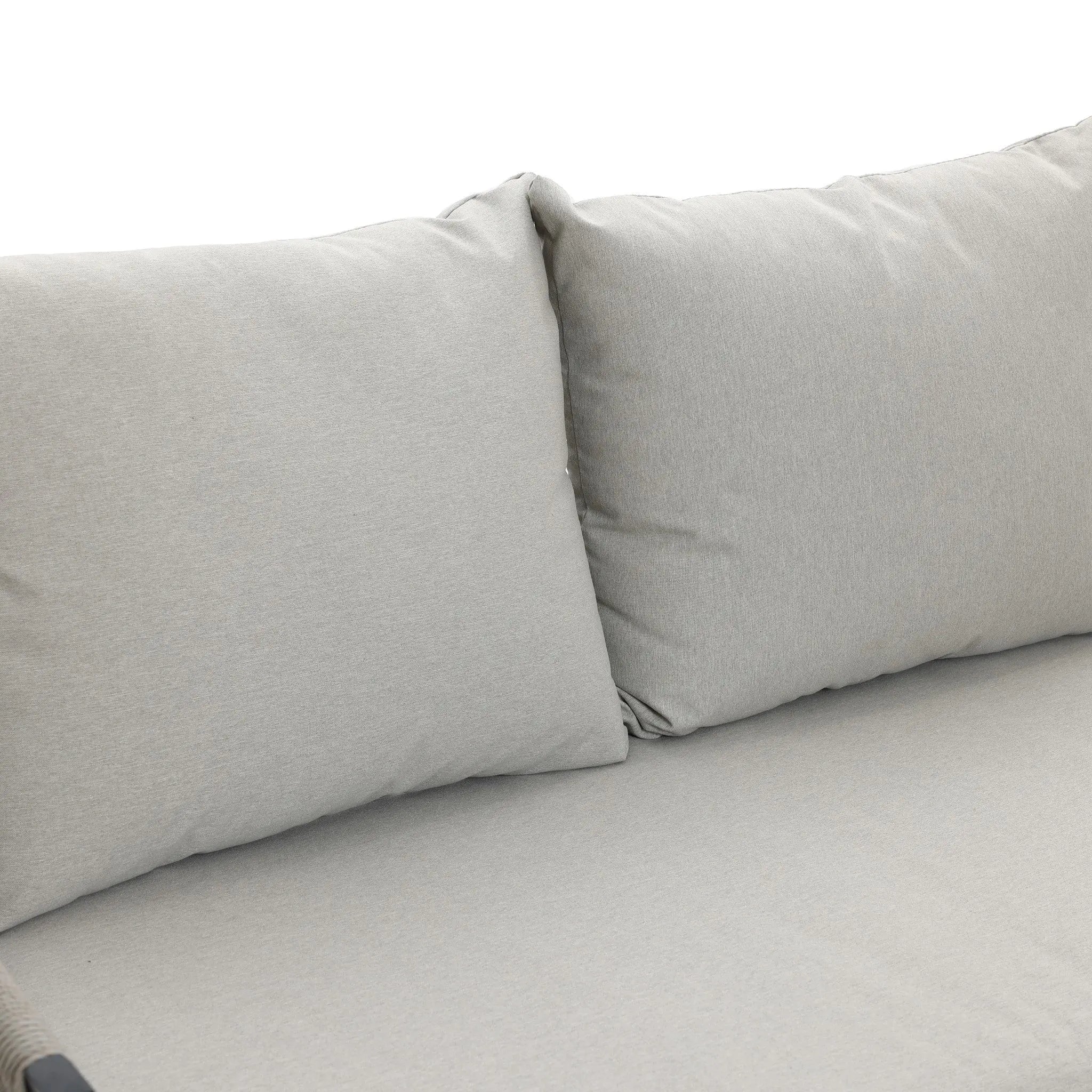 Close-up of a light gray cushioned outdoor aluminum rattan sofa with two large backrest cushions, perfect for any patio furniture set.