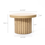 This round wooden coffee table features a modern design with a fluted base. It boasts an oak finish with dimensions: diameter 23.62, height 16.14, base diameter 15.35, and base height 14.17. The top thickness is 1.97.