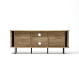 The Aria oak finish TV stand by LuxenHome, designed for TVs up to 55 inches, features a minimalist mid-century modern style with three sliding doors and circular cutouts. Elevated on black metal legs, it offers enclosed storage. The image showcases it on a clean, white background.