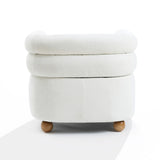 A round, white ottoman with a plush top and wooden ball legs exudes modern charm. Its soft fabric is perfect against a plain background, blending seamlessly with the Tia ivory barrel accent chair by LuxenHome.