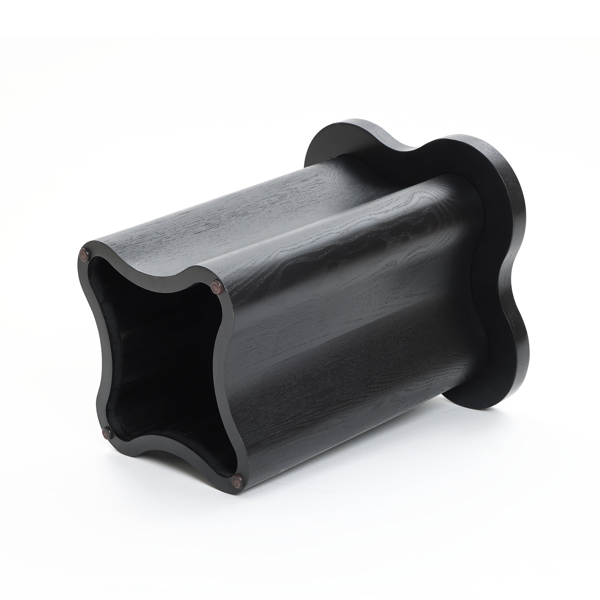 Black, hollow, modern-style side table crafted from premium MDF wood, featuring a wavy black cloverleaf shape with a matching base, placed on its side against a white background.