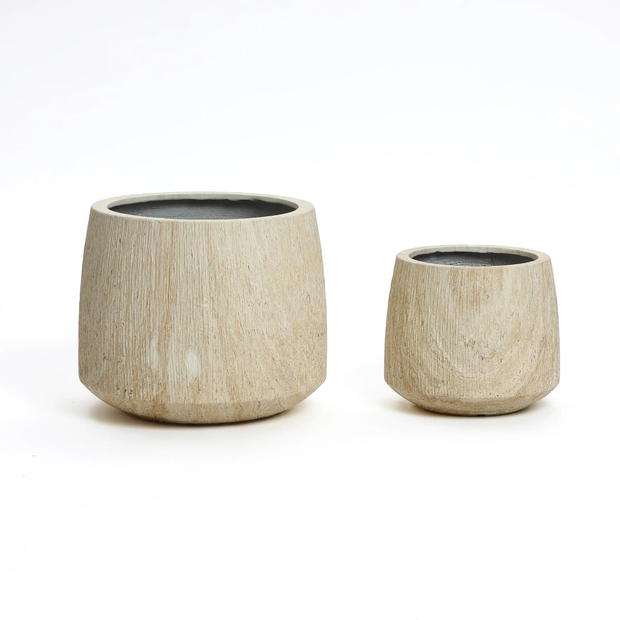 Two textured, ribbed texture planters in light brown finish, cylindrical in shape, come in different sizes on a white background. Perfect for both indoor and outdoor settings, these planters beautifully blend style and functionality.