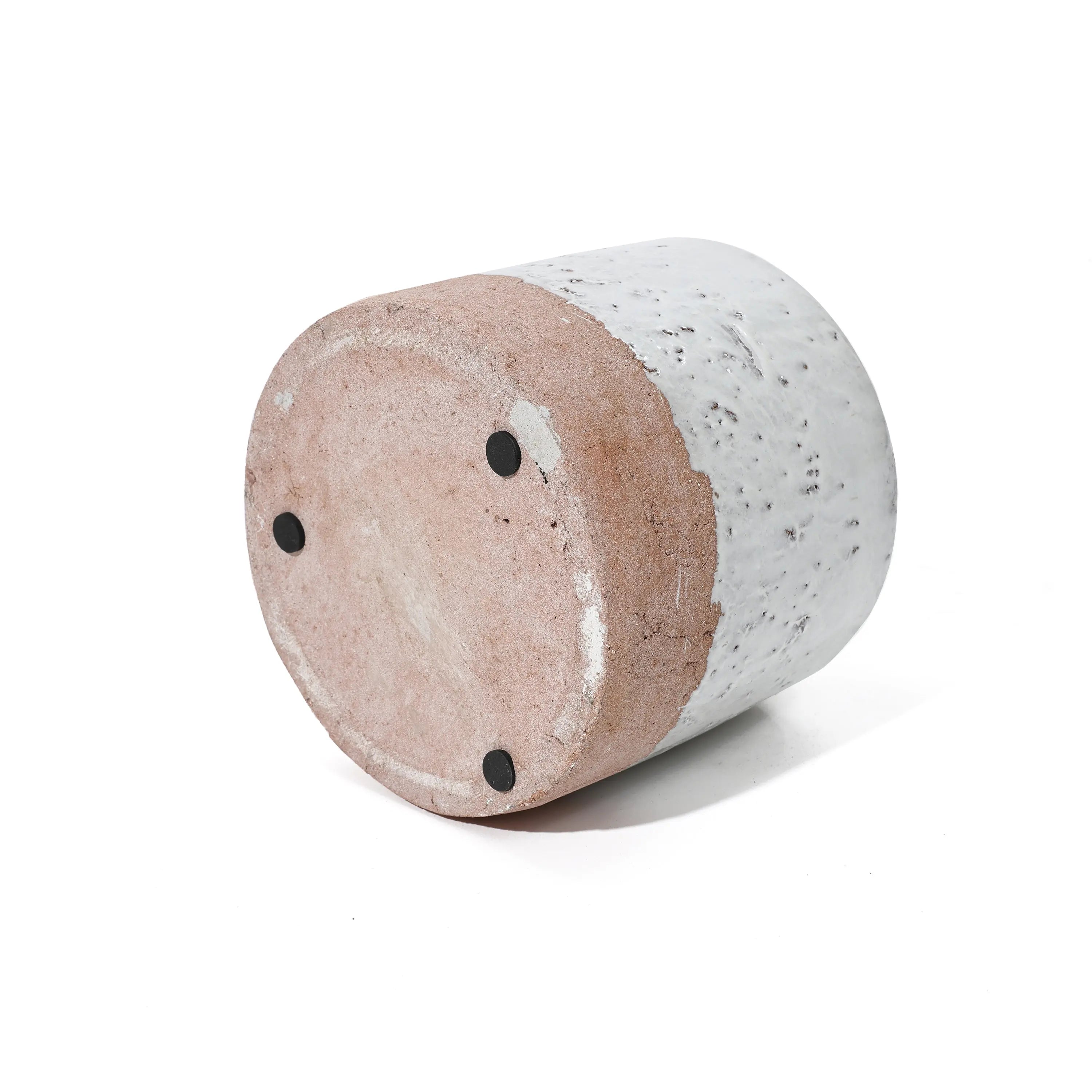 Gray-speckled cylindrical stool or side table with a light brown base, reminiscent of a stoneware vase, viewed from an angle.