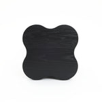 A black cloverleaf shape, modern-style side table crafted from premium MDF wood with a visible grain pattern is pictured against a plain white background.