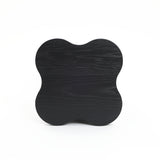 A black cloverleaf shape, modern-style side table crafted from premium MDF wood with a visible grain pattern is pictured against a plain white background.