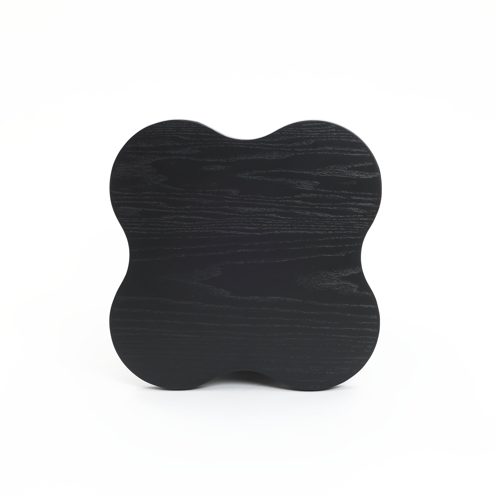 A black cloverleaf shape, modern-style side table crafted from premium MDF wood with a visible grain pattern is pictured against a plain white background.
