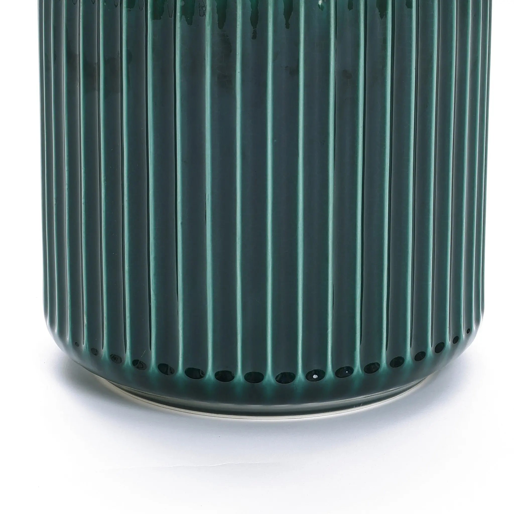 Close-up of a LuxenHome Jade green ribbed glazed round ceramic planter on a white background. The glossy finish accentuates the grooves, rendering it sleek and modern, like a contemporary plant paradise.