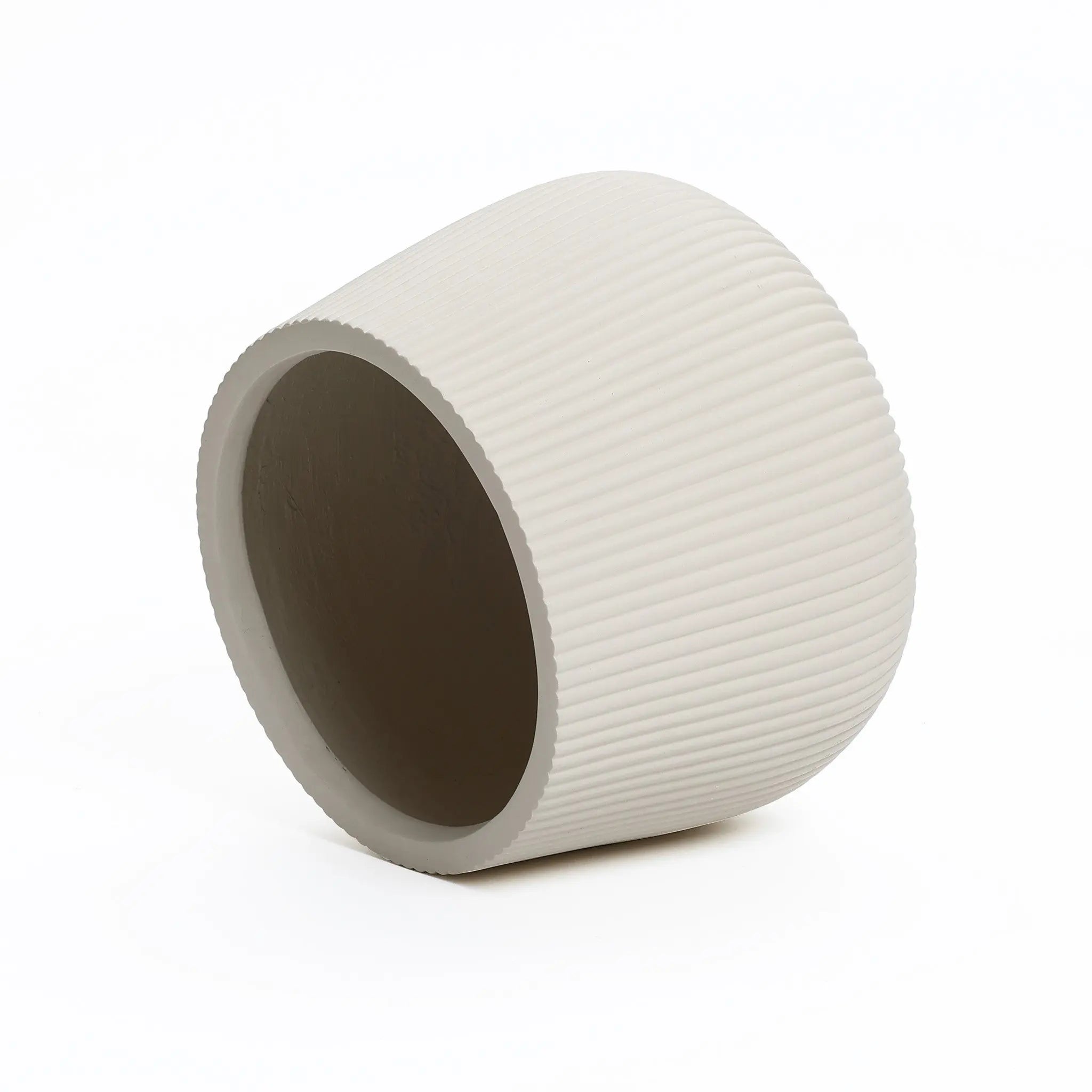 The LuxenHome Ribbed Round Planter, standing at 10.63 tall, lies tilted against a white background. This large off-white planter showcases modern minimalist design with its textured ribbed exterior and smooth circular opening.