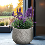 A decorative planter filled with blooming purple lavender and green foliage graces the patio, set against blurred greenery and sunlight. The eco-friendly MgO material ensures durability, while the discreet drainage hole keeps plants thriving.
