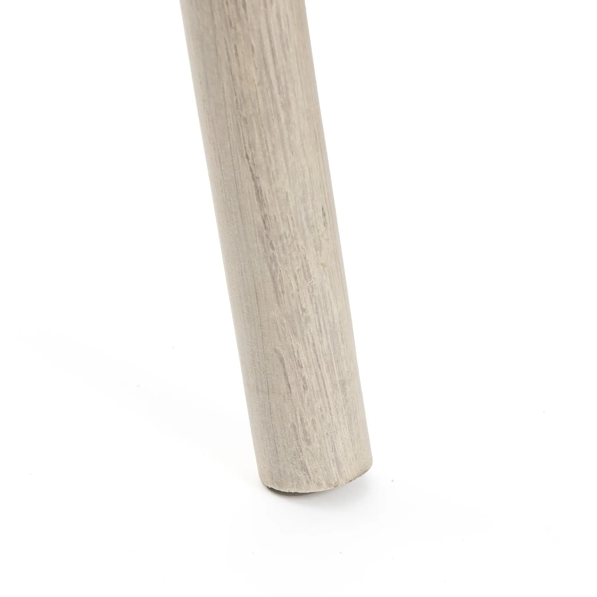 Close-up of a single wooden cylindrical leg on a flat light-colored surface, reminiscent of the rustic charm youd find in a birch wood ladder, making it an ideal home decor accessory for bringing warmth and character to your space.