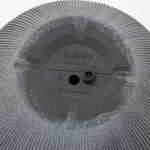 Close-up of a gray textured surface with text GL8620B and Drill Hole Here. A small circular protrusion is near the center, crafted from durable polyethylene, with markings indicating manufacturing origin. Perfect for transforming into a modern planter.