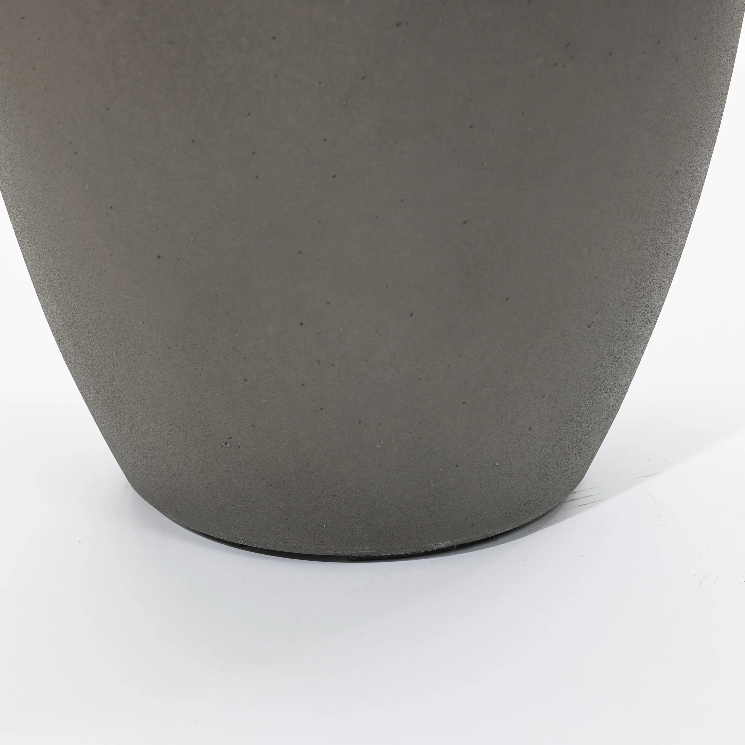 Close-up of a gray, smooth-surfaced planter on a white background, part of a modern planter set.