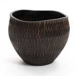 The LuxenHome dark brown textured resin round planter, large, features a ribbed pattern and geometric flair. Its asymmetric wavy top contrasts with the glossy interior, creating a unique design that sits elegantly on a white background.