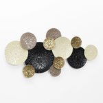 A decorative wall art piece featuring overlapping circular elements in beige, black, brown, and gold with a textured finish on a white background. This nature-inspired artwork captures the elegance of coastal abstract themes, adding a serene touch to any space.