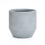 A gray, cylindrical concrete planter with a smooth matte finish sits on a white background, embodying modern minimalist design. Its weather resistance makes it ideal for both indoor and outdoor decor.