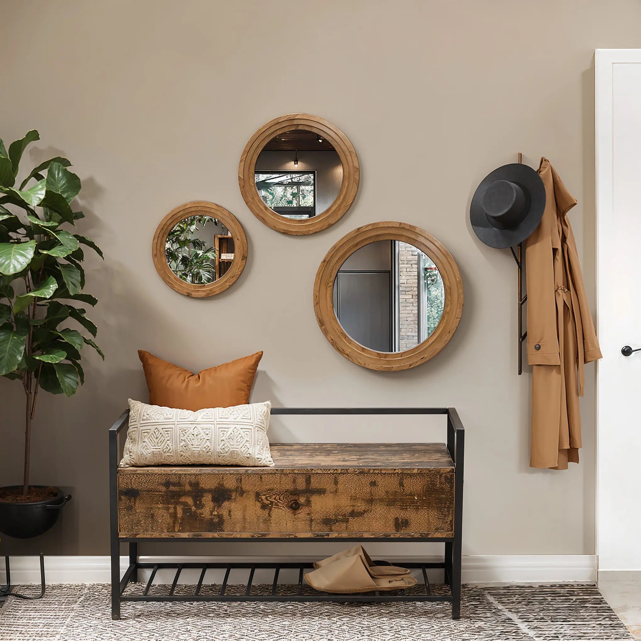 A hallway with a rubberwood framed bench, three circular mirrors creating an optical illusion, a hat, a coat, and a plant.