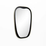 A contemporary mirror with an oblong shape and a thin, black frame beautifully adorns the white wall.