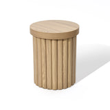 A round wooden end table with a fluted drum design, featuring a flat circular top and a column-like base in an elegant oak finish.
