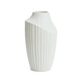 White ceramic vase with a fluted texture and a slanted top opening, resembling a modern abstract sculpture vase. This decorative piece is ideal for contemporary home decor, set elegantly against a plain white background.
