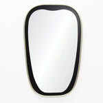 A contemporary mirror with an oblong shape and a black-and-gold frame graces a white wall.