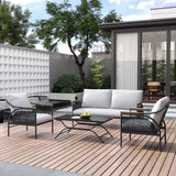 Modern outdoor patio featuring an outdoor seating set with a sofa, two chairs adorned with removable waterproof cushions, and a table on a wooden deck. A tree and plants create a lush backdrop, while a sliding glass door offers easy access inside.