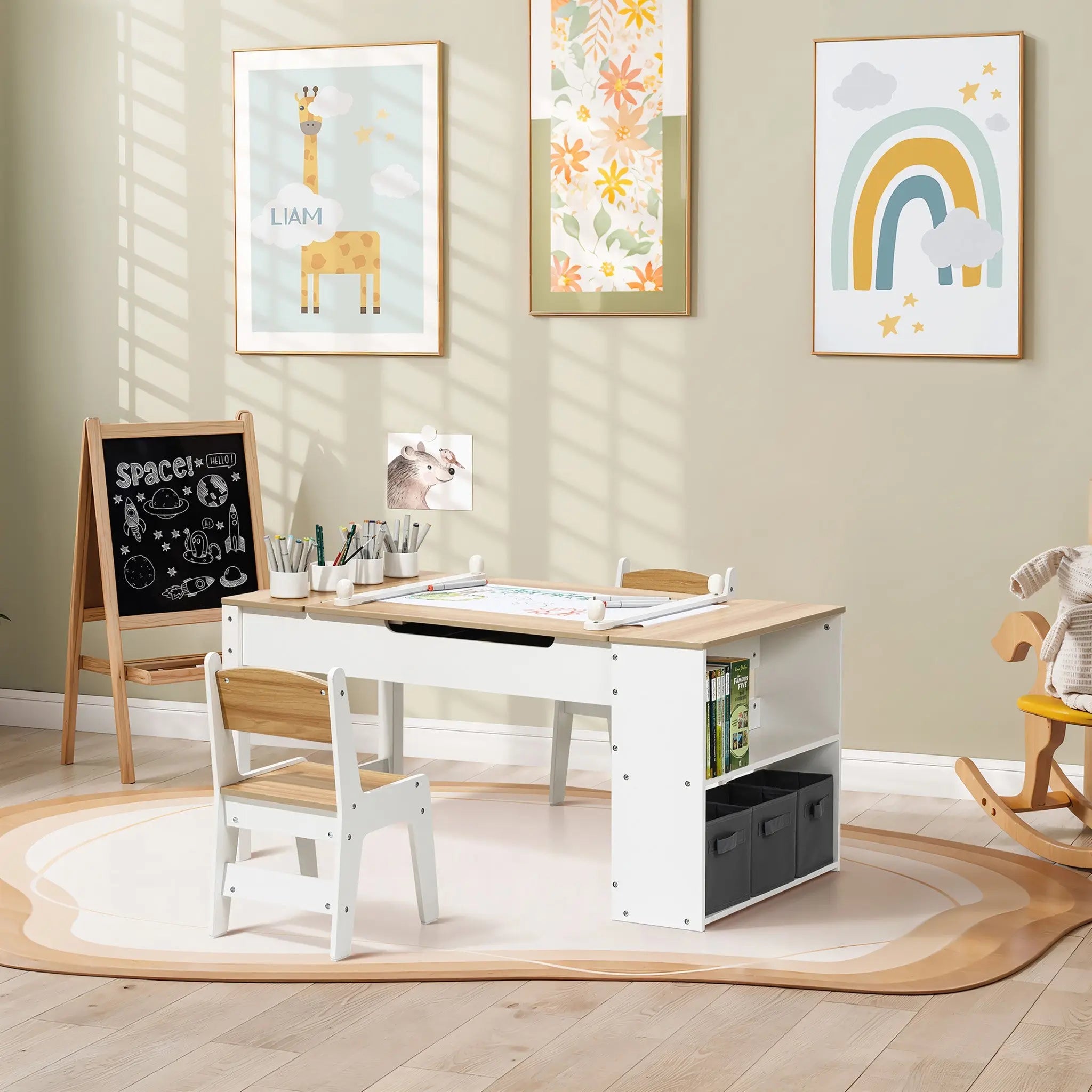 Activity Children Table with Storage Bookcase and 2 Chairs Set displayed in a bright nursery room with beige walls, featuring built-in storage, paper clamps, and adjustable height. Wooden and white finish table set shown with a mini chalkboard easel, surrounded by colorful wall art and a rocking horse.