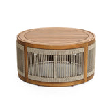 A round coffee table crafted from acacia wood features a slatted top and hand-woven rope sides, perfect for both indoor and outdoor use.