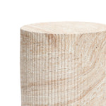 Experience the charm of a travertine-style side table, featuring a textured cylindrical design with vertical grooves. The natural beige and brown patterns stand out beautifully against a white background, perfectly enhancing both indoor and outdoor aesthetics.