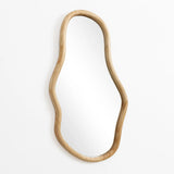 Irregular oval-shaped mirror with a curved wooden frame, crafted from natural pine wood, making a decorative statement against a plain white background.
