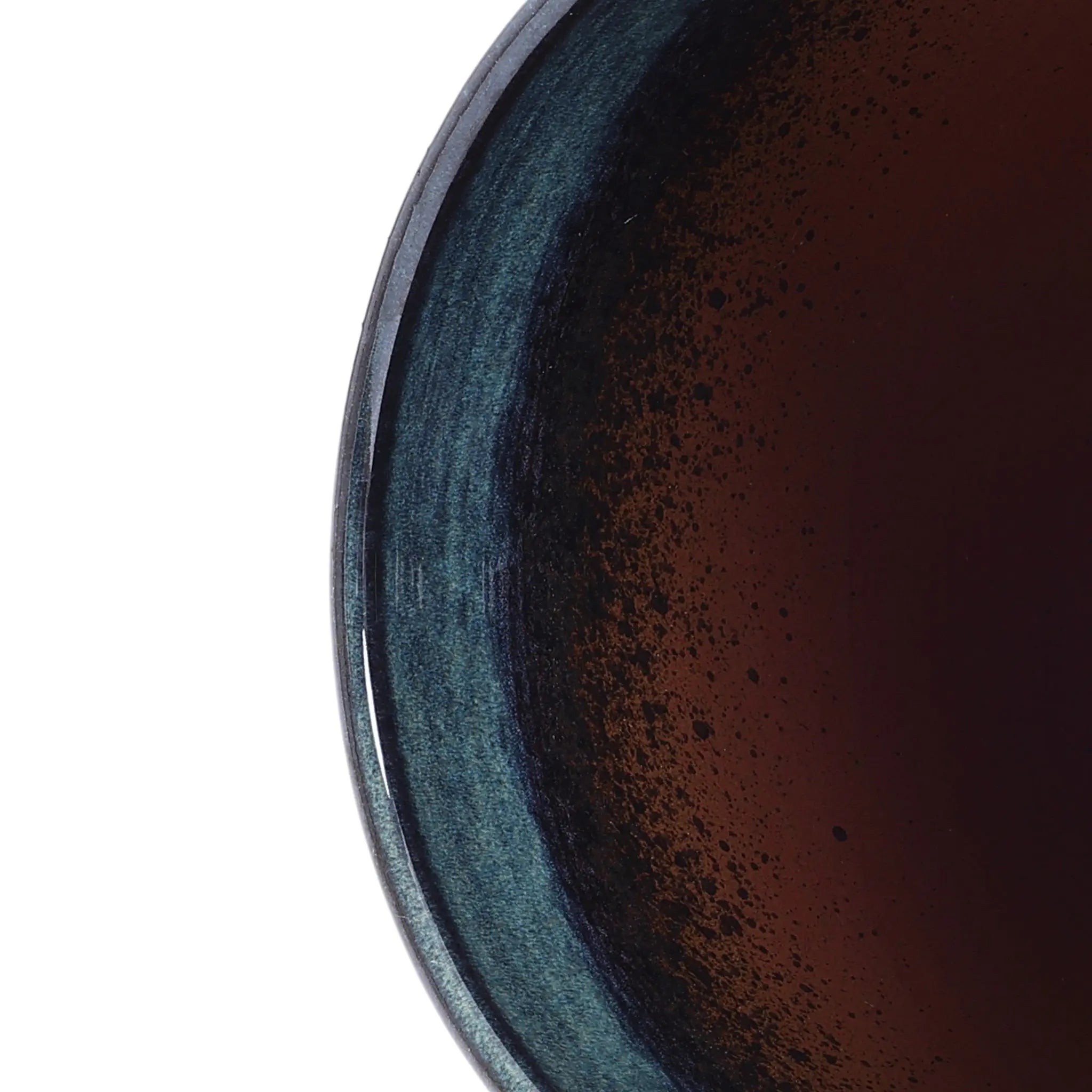 A close-up of a dark liquid in the LuxenHomes Marina gray glazed round ceramic planter, 11.22 h, showcases subtle reflections on its smooth blue and black gradient inner rim.