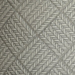 Close-up of a textured pattern featuring diagonal, interwoven zigzag lines forming a herringbone design on a gray MgO material surface.