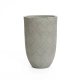 Tall cement planter with a textured, crisscross pattern. Gray in color, cylindrical shape, and smooth opening at the top. Perfect for a modern minimalist design.
