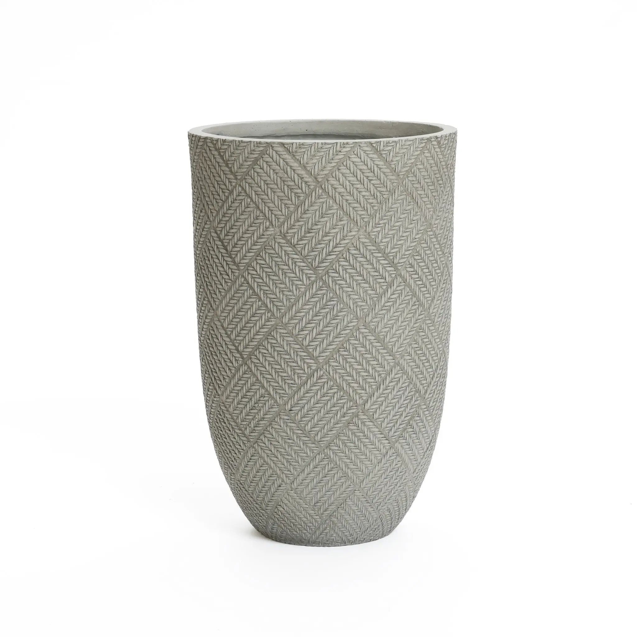 Tall cement planter with a textured, crisscross pattern. Gray in color, cylindrical shape, and smooth opening at the top. Perfect for a modern minimalist design.