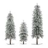 Three snow-frosted pine trees of varying heights, with lifelike PVC branches, stand on square metal bases against a white background—perfect for creating a winter wonderland indoors.