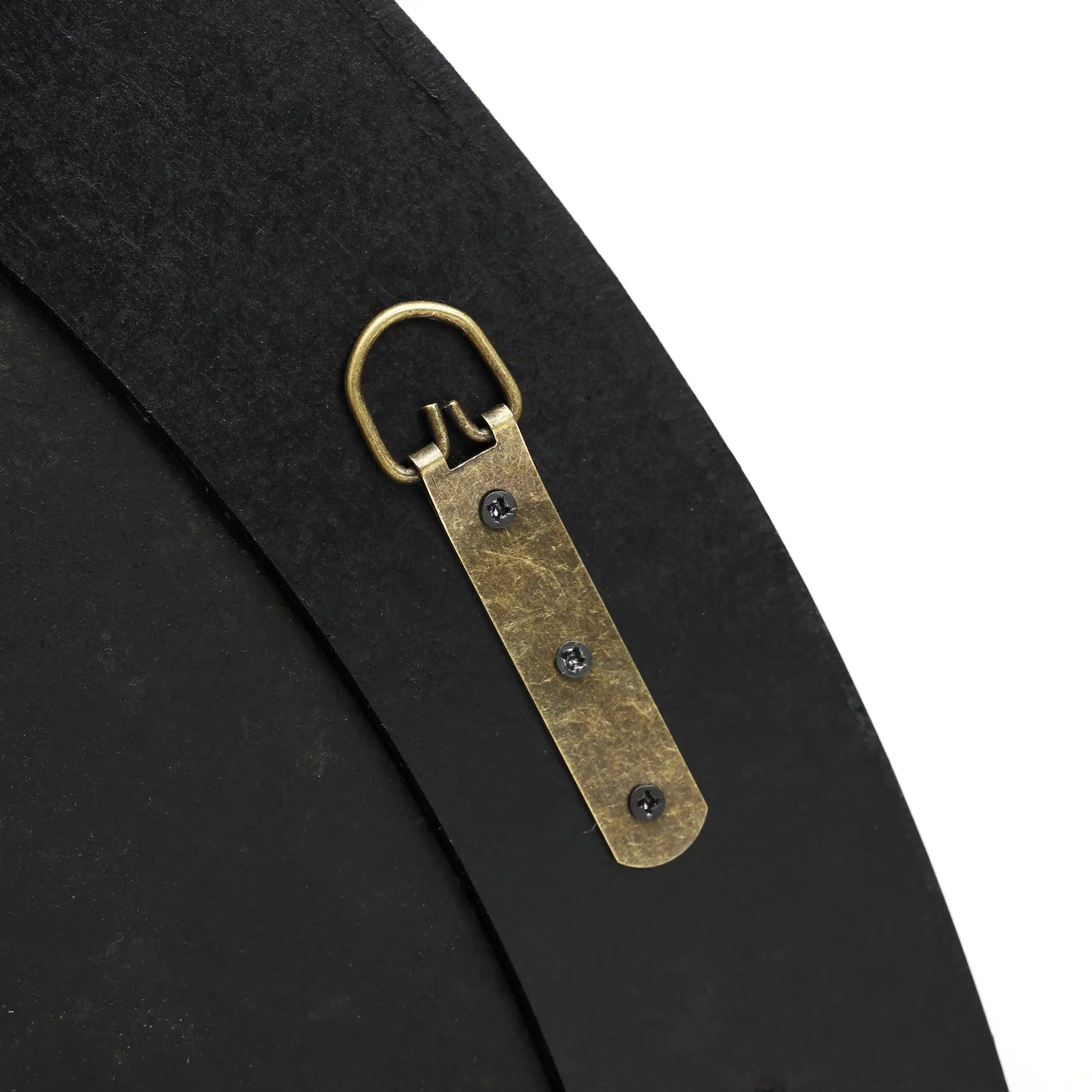 Close-up of a brass hanger attached to a flat, dark surface with three screws, featuring a round loop at the top. This elegant addition is perfect for holding a round mirror or accentuating furniture with poplar burl veneer and a burlywood MDF frame.