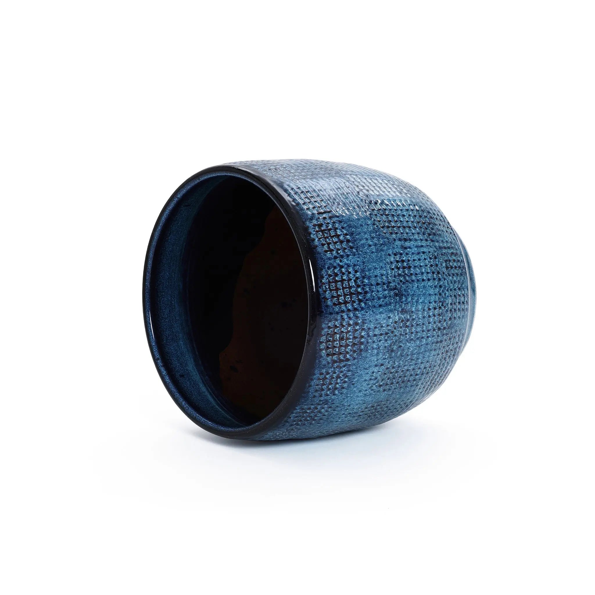 An Ocean blue glazed round ceramic planter by LuxenHome, featuring a speckled gradient with a dark interior and handcrafted design, lies on its side against a plain white background.