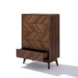 The LuxenHome Theo 5-drawer chest, featuring a mid-century modern design with a herringbone pattern, is crafted in a walnut finish. Its bottom drawer appears slightly open, and the vertical dresser stands on angled legs, casting a shadow on the white background.