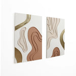 Two stunning abstract metal wall decor pieces featuring wavy lines and shapes in beige, brown, and gold tones are mounted on a pristine white wall.