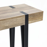 A close-up of a modern farmhouse console table featuring an oak finish tabletop with black metal legs and accents, showcasing a minimalist, contemporary design.