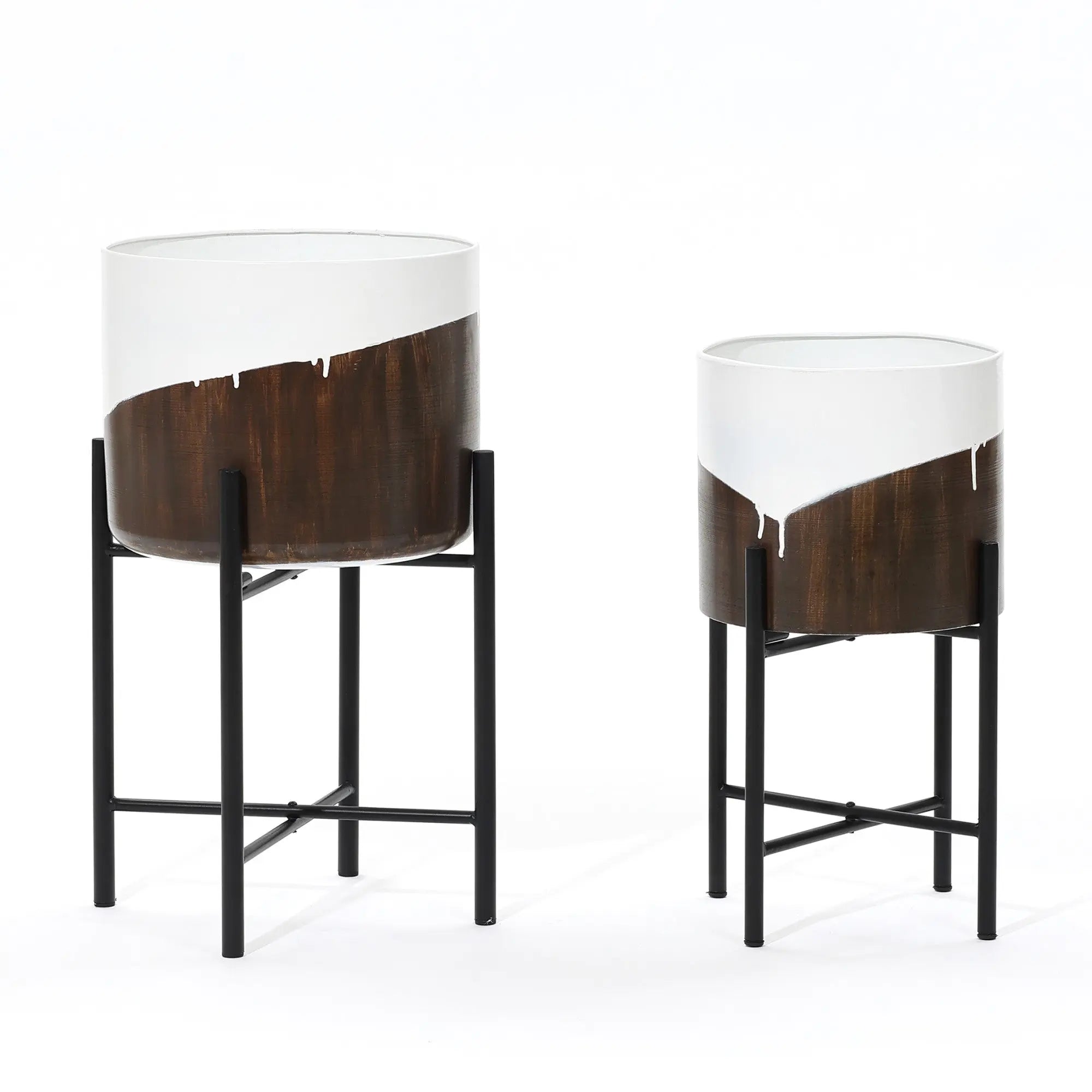 Two cylindrical metal cachepot planters on black stands create a unique dynamic visual effect, featuring a brown base with an irregular white upper section. One planter is larger than the other, making them perfect for home decor.