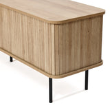 An oak TV stand featuring vertical grooves, rounded corners, and black metal legs, this cabinet is designed to complement a 65-inch TV effortlessly. With its stylish tambour doors, it adds a touch of elegance and modernity to any living space.
