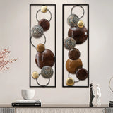 Two rectangular metal wall art pieces with circular and spiral elements in brown, gold, and silver tones create striking metal wall decor above a modern console table with decorative items.