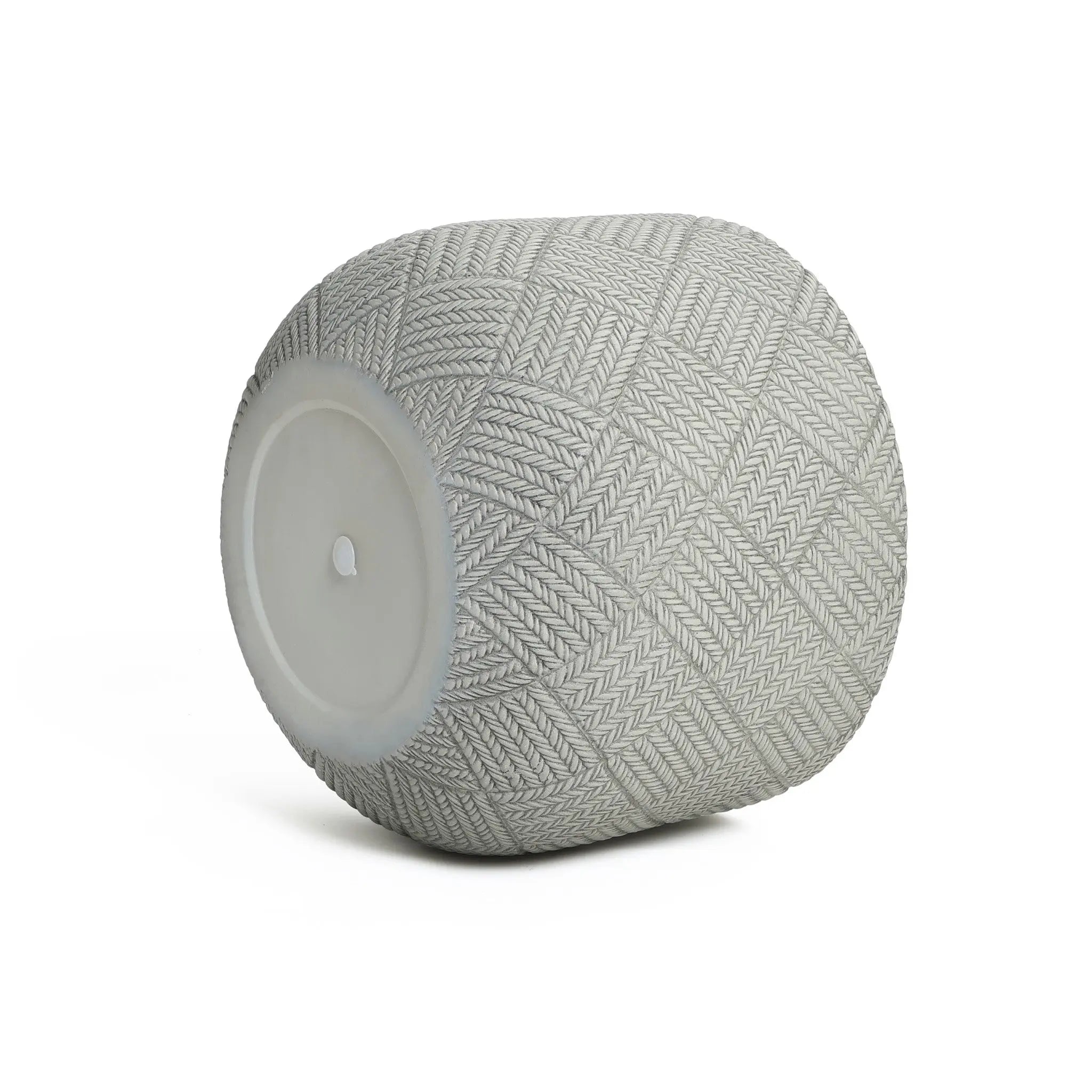 Gray, textured, cylindrical planter crafted from MgO material, featuring a herringbone pattern and a flat white circular end with a discreet drainage hole for optimal plant care.