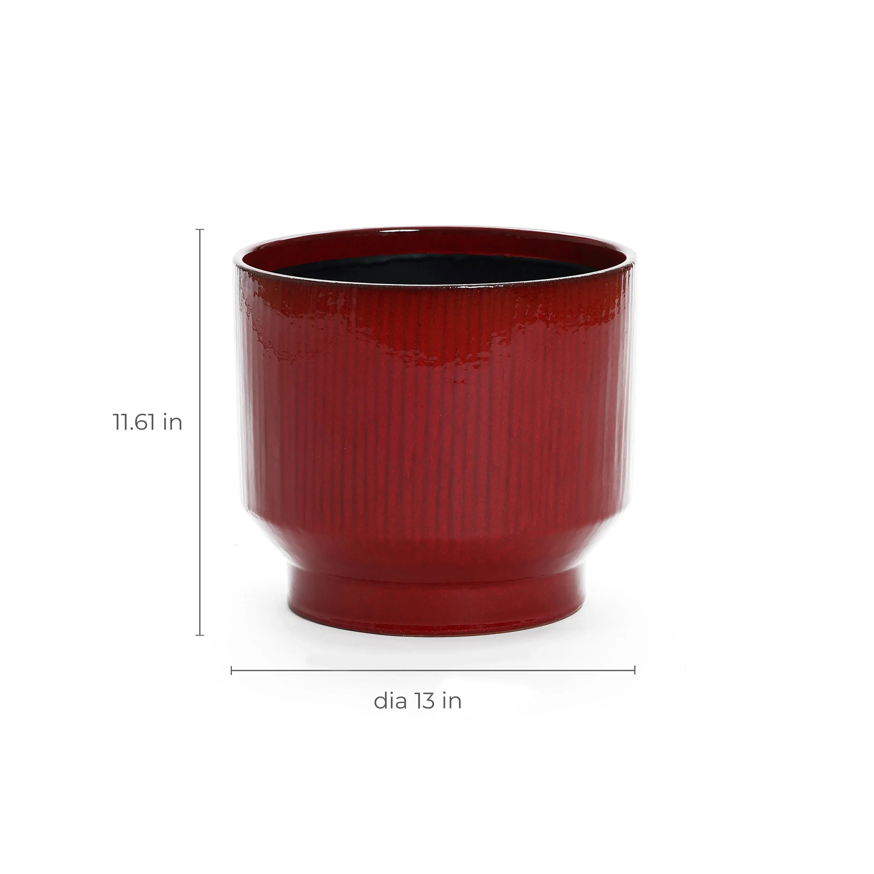 The LuxenHome burgundy red glazed round ceramic planter, measuring 11.61 tall and 12.4 in diameter, features a vertical stripe design with subtle ridges and a drainage hole for plant health, set against a plain white background.