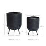 Two cachepots with tripod legs feature a distressed black finish. The larger pot planter is on the left, and the smaller on the right, with dimensions and interior measurements conveniently labeled above and below each planter.
