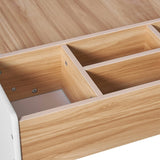 A close-up of an open drawer with two compartments inside a light-colored LuxenHome children play table from the Play Table and Bookcase Set. The wooden drawer boasts a smooth finish, minimalist design, and visible screws on its side panel.