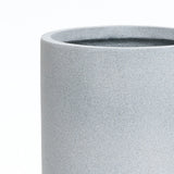 A gray round planter with a smooth texture, embodying modern minimalist decor, is showcased against a plain white background. Its design ensures it doubles as a weather-resistant planter, perfect for indoors or out.