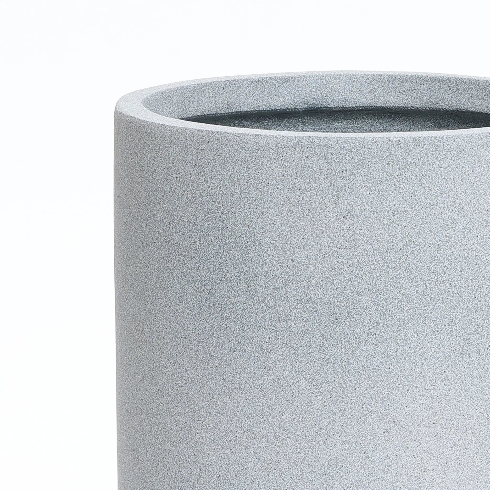 A gray round planter with a smooth texture, embodying modern minimalist decor, is showcased against a plain white background. Its design ensures it doubles as a weather-resistant planter, perfect for indoors or out.