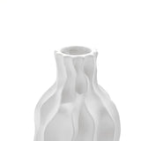 A versatile piece, this white ceramic vase features a wavy, textured design against a plain white background.