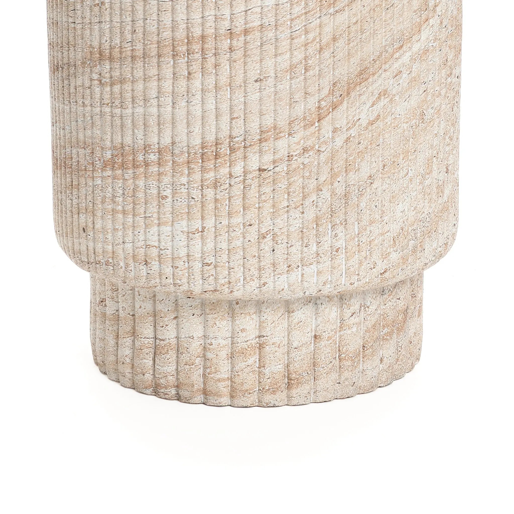 Close-up of a textured, cylindrical stone column with horizontal grooves and a sand-colored pattern, reminiscent of travertine-style side table designs that effortlessly complement both indoor and outdoor aesthetics.